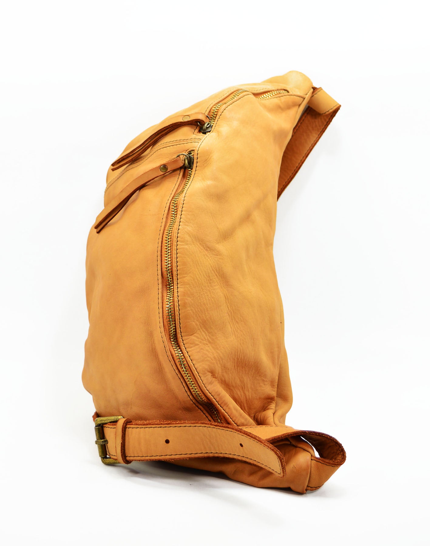 Large crossbody sling bag made with lusciously soft Italian leather in cognac. Laid flat.